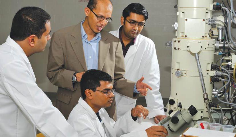 A student in a lab with a professor while earning her biology degree in CT